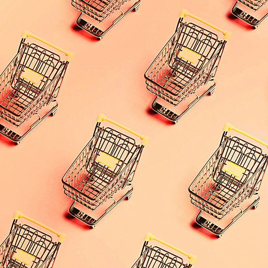 Shopping carts on pink background